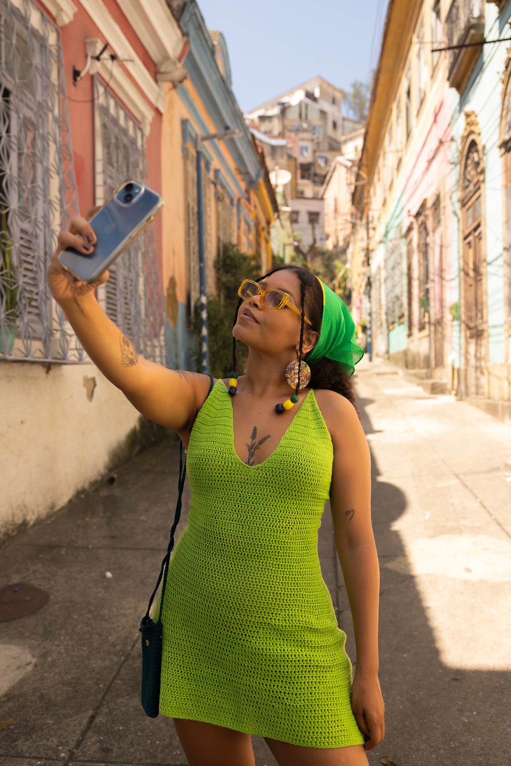 Woman Taking a Photo of Herself Wearing a Crocheted Dress